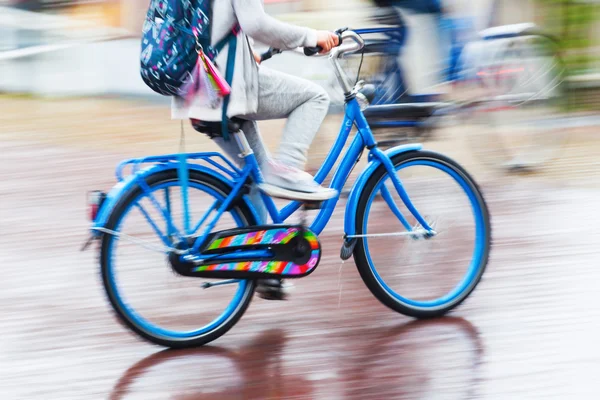 Bicycle rider in the rainy city