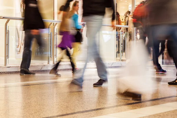 People in motion blur in a mall