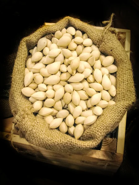 Pistachios heap seed against in rattan bag and wood box