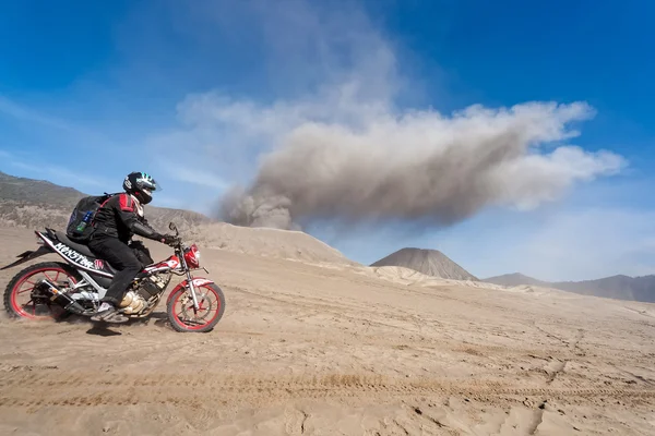 Motorcyclist traveler across the volcano