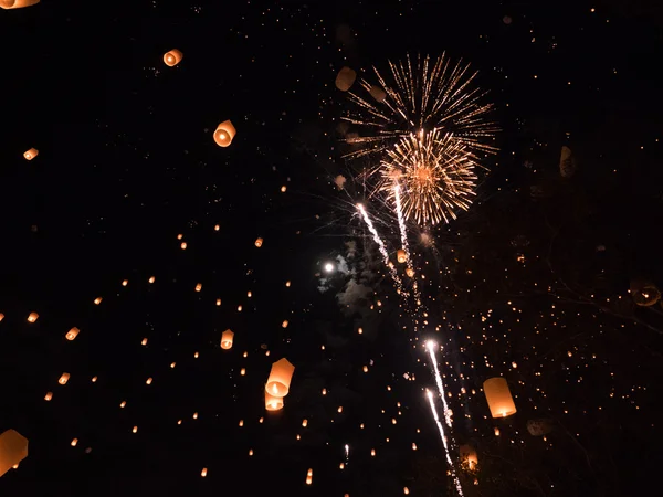 Lanterns and fireworks in sky