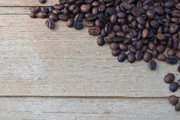 Coffee beans in rustic wood background - overhead view