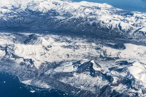 Aerial view over ice mountains in Greenland
