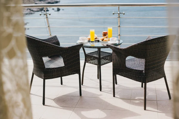Breakfast for two persons on a balcony with beautiful sea view