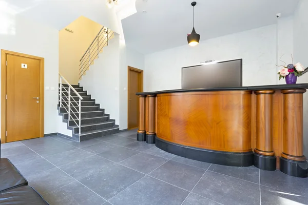 Wooden reception desk in hotel lobby