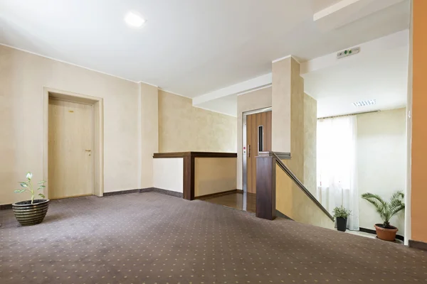Hotel lobby interior with elevator and stairs