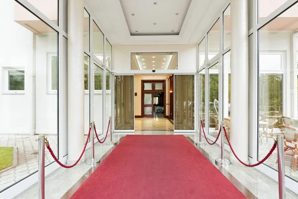 Elegant luxury hotel entrance with red carpet