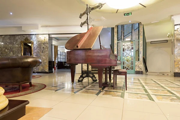 Interior of a luxury hotel lobby with piano