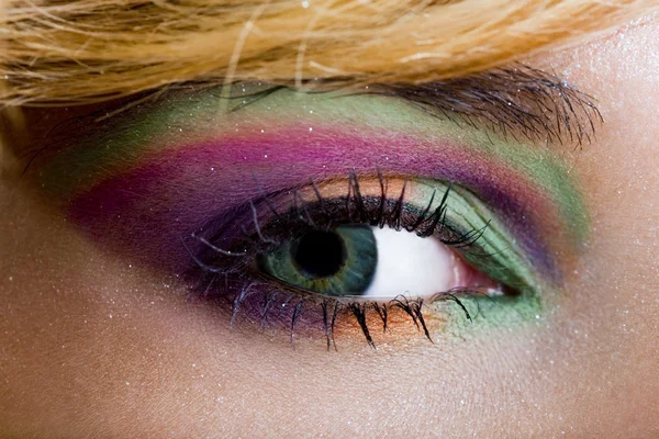 Macro of an eye with multi-colored make-up