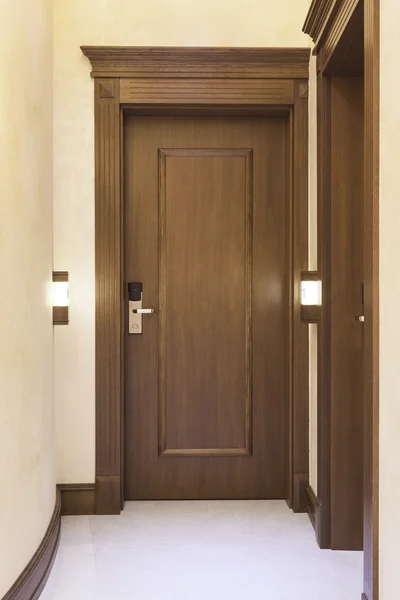 Wooden door with number light in hotel