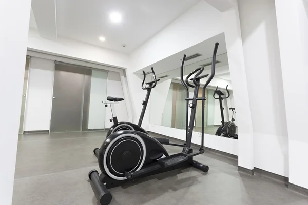 Elliptical trainer and bike in exercise room