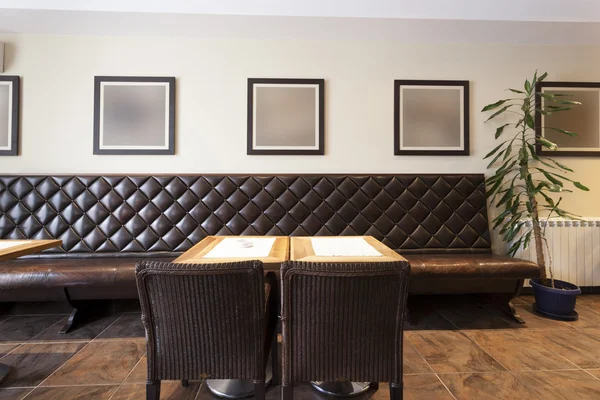 Cafe interior with empty picture frames