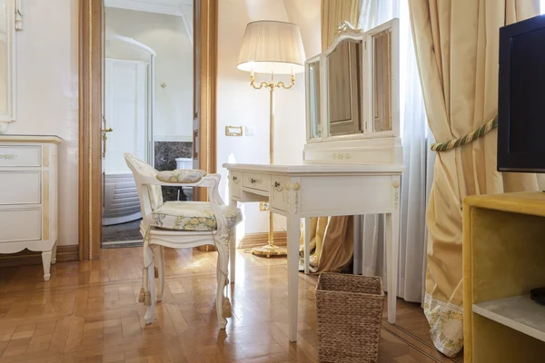 Vintage chair and desk with vanity mirror in luxury home