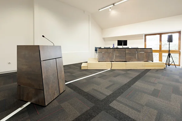 Speech podium and desk in modern conference hall