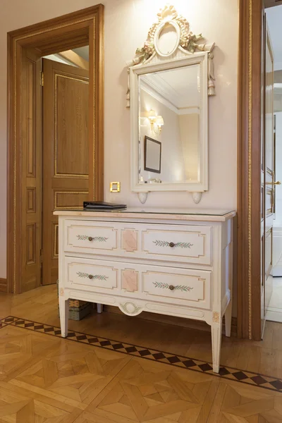 Vintage cabinet and mirror in fancy room interior