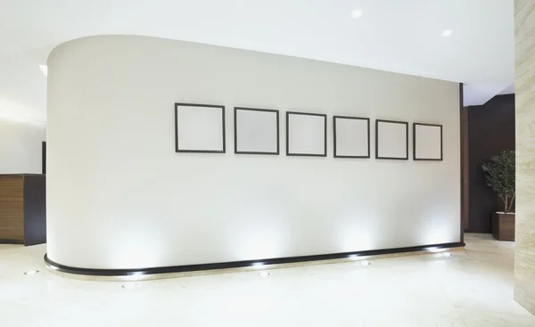 Empty picture frames in luxury building corridor