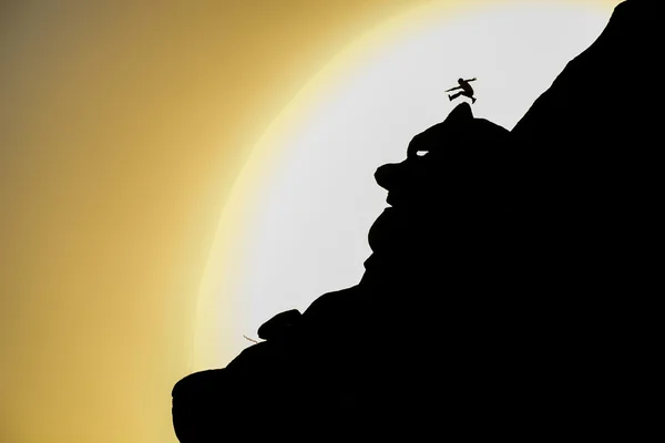 Crazy peak climbing and jumping man silhouette