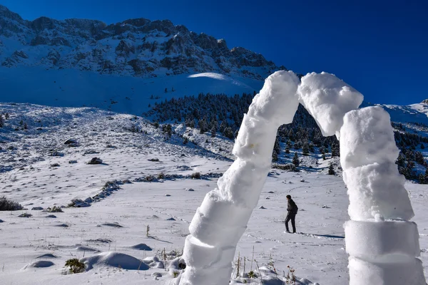 A man walking alone in the snowy mountains