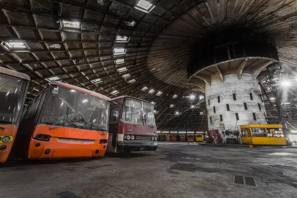 Abandoned bus depot with amazing construction circus and colored buses