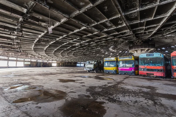 Abandoned bus depot with amazing construction circus and colored buses