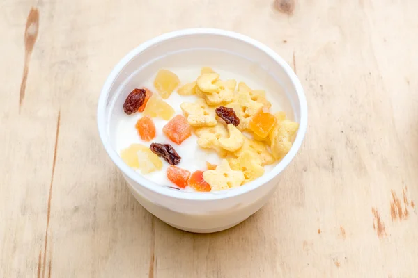 Flakes and dried fruit with yogurt