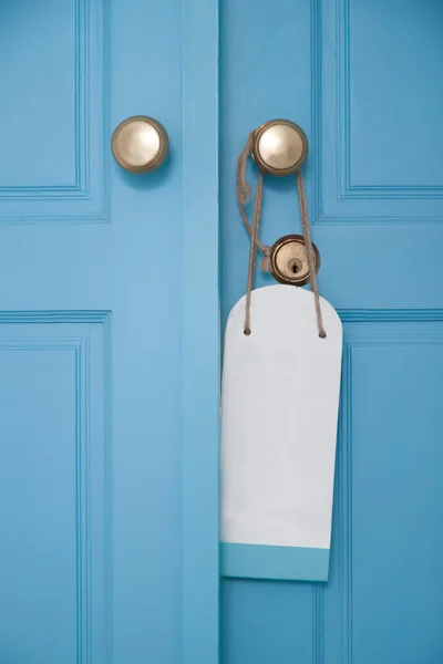 Blue door with hanging sign