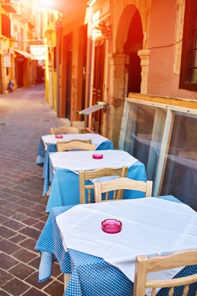 Empty tables of street cafes