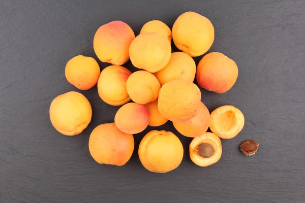 Fresh apricots on line isolated on blackboard