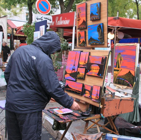 Artist painting pictures on street