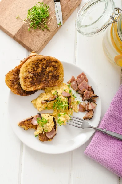 Scrambled eggs with French toast topped with watercress Scrambled eggs with watercress, french toast