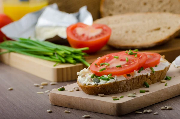 Healthy breakfast - homemade beer bread with cheese, tomatoes and chives