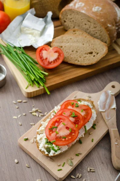 Healthy breakfast - homemade beer bread with cheese, tomatoes and chives