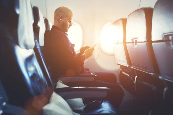 Hipster guy listening to music in headphones