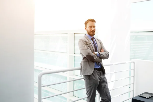 Confident male successful business worker in luxury suit is waiting meeting with brokers