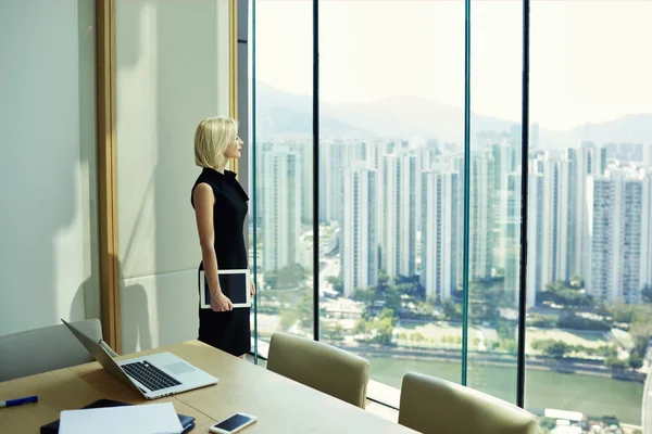 Thoughtful woman professional banker in office