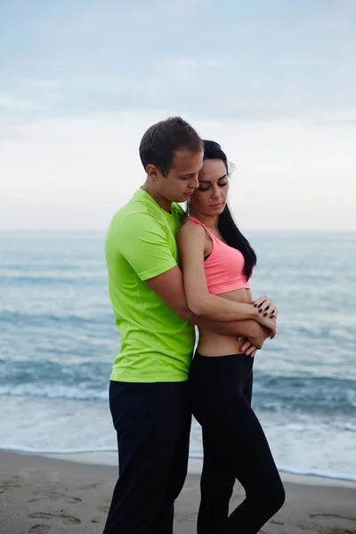 Romantic couple in love, cheerful couple of young man and woman embracing each to other, beautiful young couple embracing standing on the beach,  couple of sweethearts in love