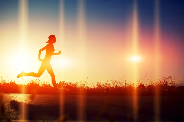 Woman running at sunset