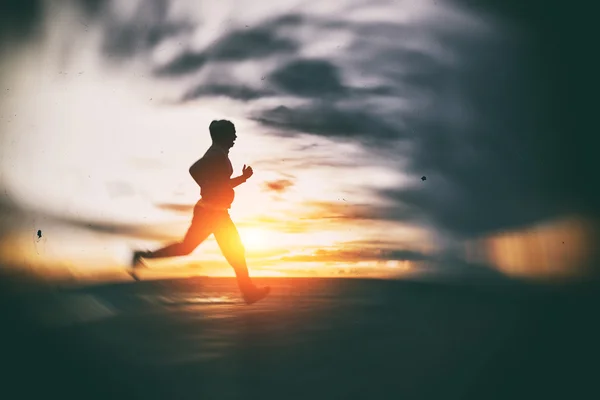 Athlete running at seaside