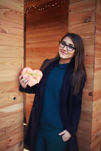 Woman holding red heart gift box