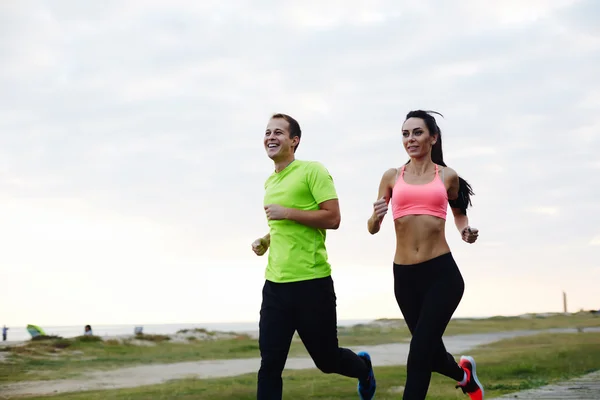 Young smiling couple running