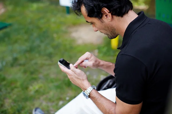 Man texting message on mobile phone