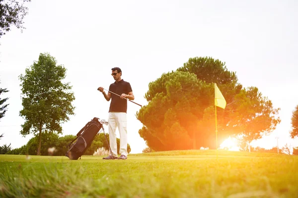 Man playing golf at beautiful summer day