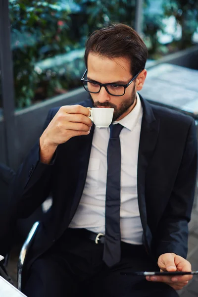 Businessman in glasses drink coffee