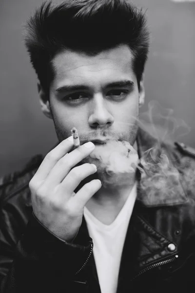 Model smoking cigarette and exhaling the fume