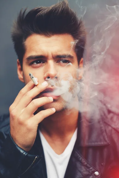 Man exhaling cigarette smoke
