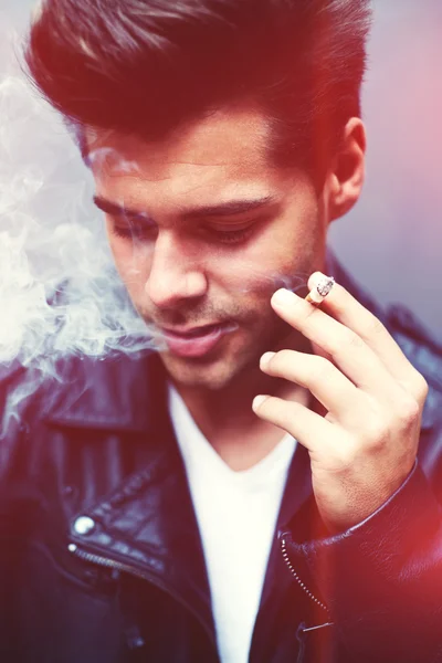 Man exhaling cigarette smoke