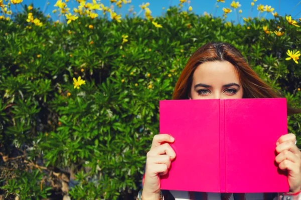 Young woman with pink book