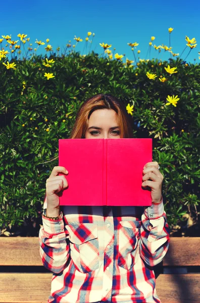 Young woman with pink book