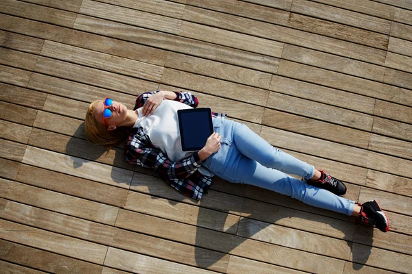 Woman lying on the wooden jetty