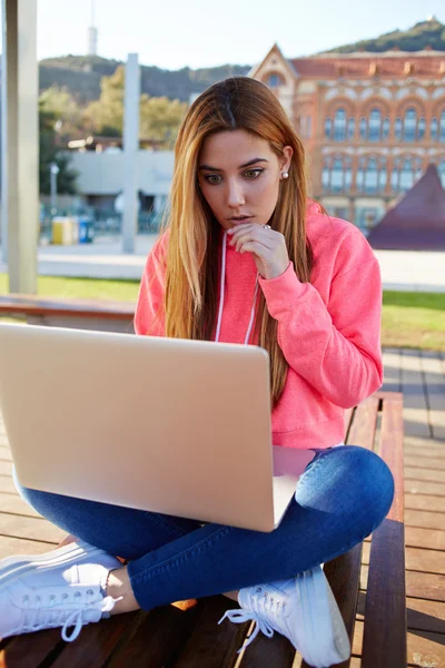 Student sitting with open laptop computer